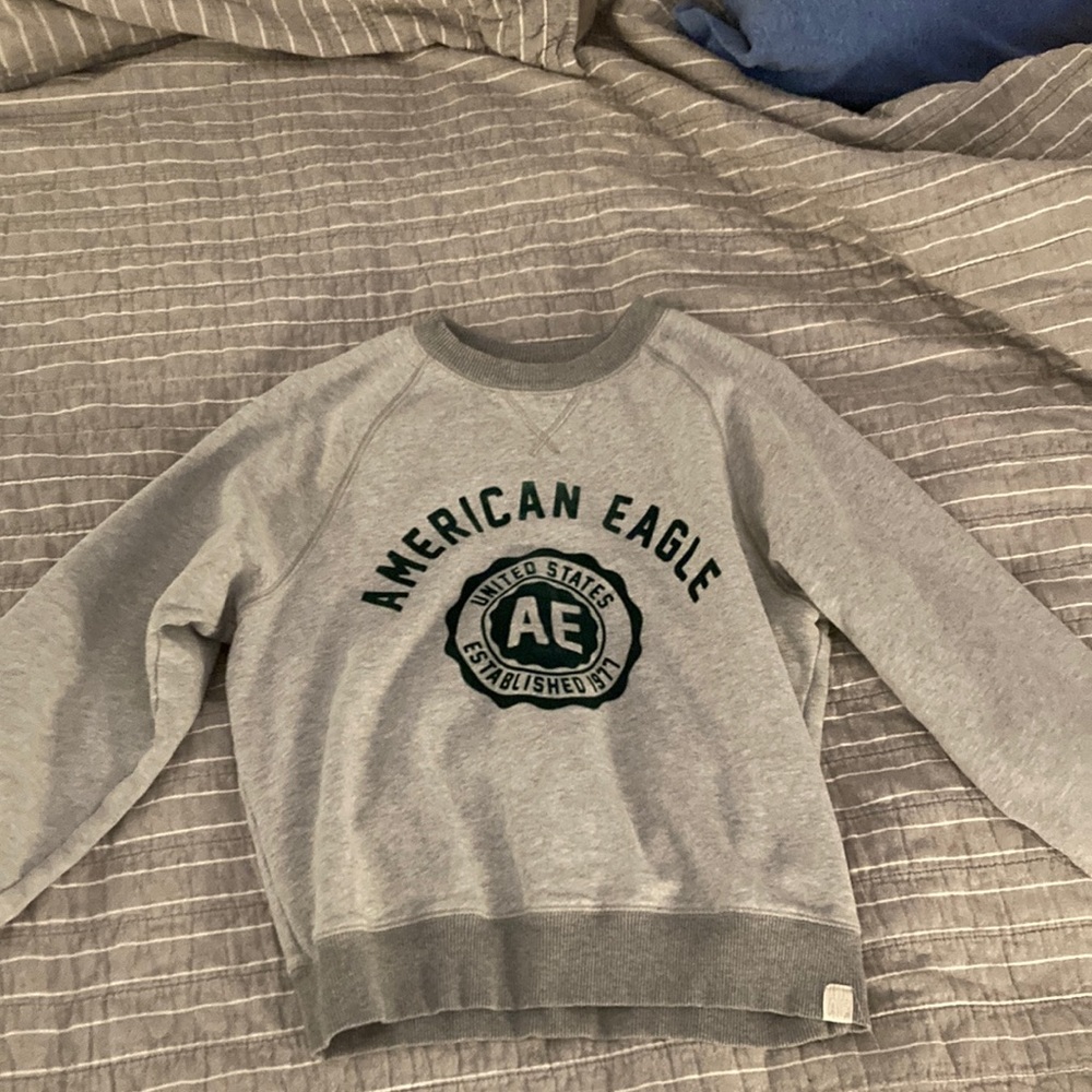 This is a gray american eagle sweatshirt with green print
